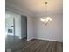 Inviting dining room featuring a modern chandelier and seamless access to a living area with a fireplace at 10502 Oak Bend Blvd, Indianapolis, IN 46239