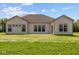 Back exterior view of the home showcasing multiple windows and a neutral color scheme at 10502 Oak Bend Blvd, Indianapolis, IN 46239