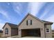 New gray brick home with attached garage and gabled roof, with visible construction materials inside garage at 10502 Oak Bend Blvd, Indianapolis, IN 46239