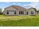 Exterior view of the back of the home featuring ample windows, and a well-maintained lawn at 10502 Oak Bend Blvd, Indianapolis, IN 46239