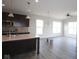 Open concept kitchen boasts an island, dark cabinetry, stainless steel appliances, and hardwood flooring at 10502 Oak Bend Blvd, Indianapolis, IN 46239