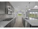 Modern kitchen with an open-concept design, gray cabinets, stainless appliances, and center island at 10502 Oak Bend Blvd, Indianapolis, IN 46239
