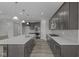 Modern kitchen with stainless steel appliances, gray cabinetry, and a center island with sink at 10502 Oak Bend Blvd, Indianapolis, IN 46239