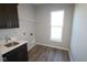Convenient laundry room equipped with a sink, storage cabinet, and a window for natural light at 10502 Oak Bend Blvd, Indianapolis, IN 46239