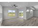 Bright living room with large windows and sliding door, complemented by stylish light fixture at 10502 Oak Bend Blvd, Indianapolis, IN 46239