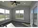 Bright sunroom with large windows offering picturesque views of the surrounding landscape and plank flooring at 10502 Oak Bend Blvd, Indianapolis, IN 46239