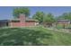 Spacious backyard featuring a well-maintained lawn, garden, and brick exterior at 1231 S Catherwood Ave, Indianapolis, IN 46203