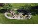 A captivating backyard pond is showcased in this aerial shot, surrounded by a lush, green lawn and charming landscaping at 1231 S Catherwood Ave, Indianapolis, IN 46203