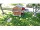 Aerial view of backyard featuring a shed with a balcony, a well-maintained lawn, and mature trees at 1231 S Catherwood Ave, Indianapolis, IN 46203