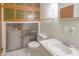Bathroom featuring a toilet, sink, and unique storage at 1231 S Catherwood Ave, Indianapolis, IN 46203