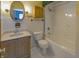 Bathroom featuring a shower-tub combo, sink, and tiled floor at 1231 S Catherwood Ave, Indianapolis, IN 46203