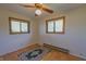 Bedroom with hardwood floors, ceiling fan, and large windows at 1231 S Catherwood Ave, Indianapolis, IN 46203