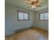 Bedroom featuring hardwood floors, wallpaper, and two windows at 1231 S Catherwood Ave, Indianapolis, IN 46203
