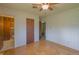 Bedroom with hardwood floors, wallpaper, and access to bathroom at 1231 S Catherwood Ave, Indianapolis, IN 46203