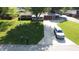 Aerial view of a single-story home with a lush green lawn, mature trees, and a long driveway at 1231 S Catherwood Ave, Indianapolis, IN 46203