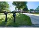 Charming single-story home with mature trees, a well-manicured lawn, and a welcoming front porch for relaxing at 1231 S Catherwood Ave, Indianapolis, IN 46203