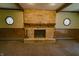 Stone fireplace in the living room with interesting octagon shaped windows at 1231 S Catherwood Ave, Indianapolis, IN 46203