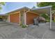 Two car garage with awning and drive, next to brown siding and brick trim at 1231 S Catherwood Ave, Indianapolis, IN 46203