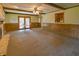 Spacious living room featuring a fireplace, ceiling fan, and sliding door access at 1231 S Catherwood Ave, Indianapolis, IN 46203