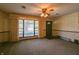 Spacious living room with large windows, neutral carpet, and overhead lighting at 1231 S Catherwood Ave, Indianapolis, IN 46203