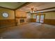 Large living room featuring a cozy stone fireplace and beamed ceilings at 1231 S Catherwood Ave, Indianapolis, IN 46203