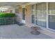 Front porch featuring white door, brick facade, awning and large windows at 1231 S Catherwood Ave, Indianapolis, IN 46203