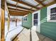 The backyard featuring a back porch with a green wall and white trim at 1235 Indiana Ave, Anderson, IN 46012