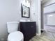 Bathroom features a modern vanity with black wood and a white porcelain toilet at 1235 Indiana Ave, Anderson, IN 46012