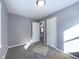 Bedroom featuring neutral walls, carpet, and two doors at 1235 Indiana Ave, Anderson, IN 46012