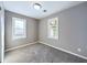 Neutral colored bedroom with carpet, two windows, and bright, neutral trim at 1235 Indiana Ave, Anderson, IN 46012