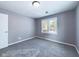 Bedroom featuring neutral walls, carpet, a window, and white trim at 1235 Indiana Ave, Anderson, IN 46012