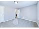 Neutral bedroom with gray carpet and walls, with an adjoining open door to the bathroom at 1235 Indiana Ave, Anderson, IN 46012