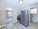 The kitchen features stainless steel appliances, gray walls, light wood flooring, and white cabinets at 1235 Indiana Ave, Anderson, IN 46012