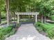 Backyard view of stone stairs and an arbor in a wooded setting at 12484 E 156Th St, Noblesville, IN 46060