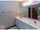 Well-lit bathroom featuring double sinks, a large mirror, and neutral walls for a clean aesthetic at 12484 E 156Th St, Noblesville, IN 46060