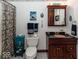 Charming bathroom with wood cabinet, decorative accents, and unique shower curtain, adding character at 12484 E 156Th St, Noblesville, IN 46060