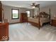 Primary bedroom with elegant furniture, plush bedding, and natural light for a cozy retreat at 12484 E 156Th St, Noblesville, IN 46060