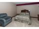 Cozy bedroom with a comfortable armchair, decorative pillows, and soft carpet, creating a relaxing retreat at 12484 E 156Th St, Noblesville, IN 46060