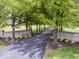 Gated entrance leading to the property with beautiful landscaping and mature trees at 12484 E 156Th St, Noblesville, IN 46060