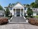 Grand home entrance with stately columns, stone steps, a double-door entry, and manicured landscaping at 12484 E 156Th St, Noblesville, IN 46060