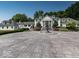Stately white home featuring columns, a circular driveway, an elegant fountain, and meticulously manicured landscaping at 12484 E 156Th St, Noblesville, IN 46060