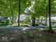Home exterior with a pergola, patio, lush gardens, and a winding paved pathway, surrounded by mature trees at 12484 E 156Th St, Noblesville, IN 46060