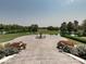 Elevated view showcasing a fountain, pond, and extensive landscaping from the front porch of this estate at 12484 E 156Th St, Noblesville, IN 46060