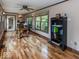 Well-lit home office with hardwood floors, a large desk, and natural light from multiple windows at 12484 E 156Th St, Noblesville, IN 46060