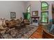 Comfortable living room with fireplace, hardwood floors, and ample natural light at 12484 E 156Th St, Noblesville, IN 46060