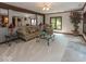 Cozy living room with comfortable seating, a ceiling fan, and natural light at 12484 E 156Th St, Noblesville, IN 46060