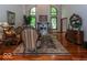 Sophisticated living room with hardwood floors, fireplace, and large windows offering serene views at 12484 E 156Th St, Noblesville, IN 46060