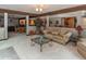 Open-concept living room with comfortable sofa, stylish glass table, and neutral palette at 12484 E 156Th St, Noblesville, IN 46060