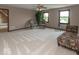 Spacious living room with neutral carpet, natural light, and comfortable seating for relaxation at 12484 E 156Th St, Noblesville, IN 46060