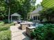 Outdoor kitchen and entertainment space with a built-in grill, bar, dining area, and cozy pavilion at 12484 E 156Th St, Noblesville, IN 46060
